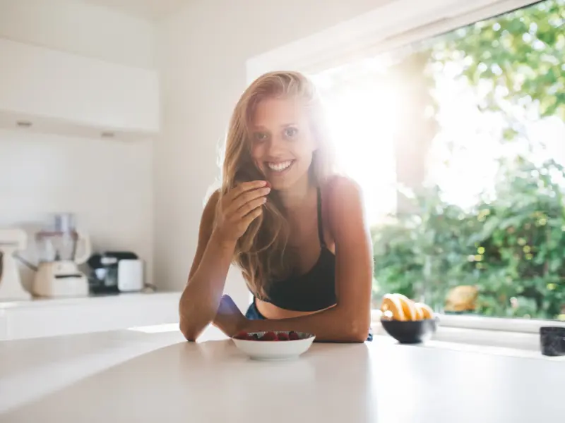 The Benefits of Blueberries. Woman eating blueberries